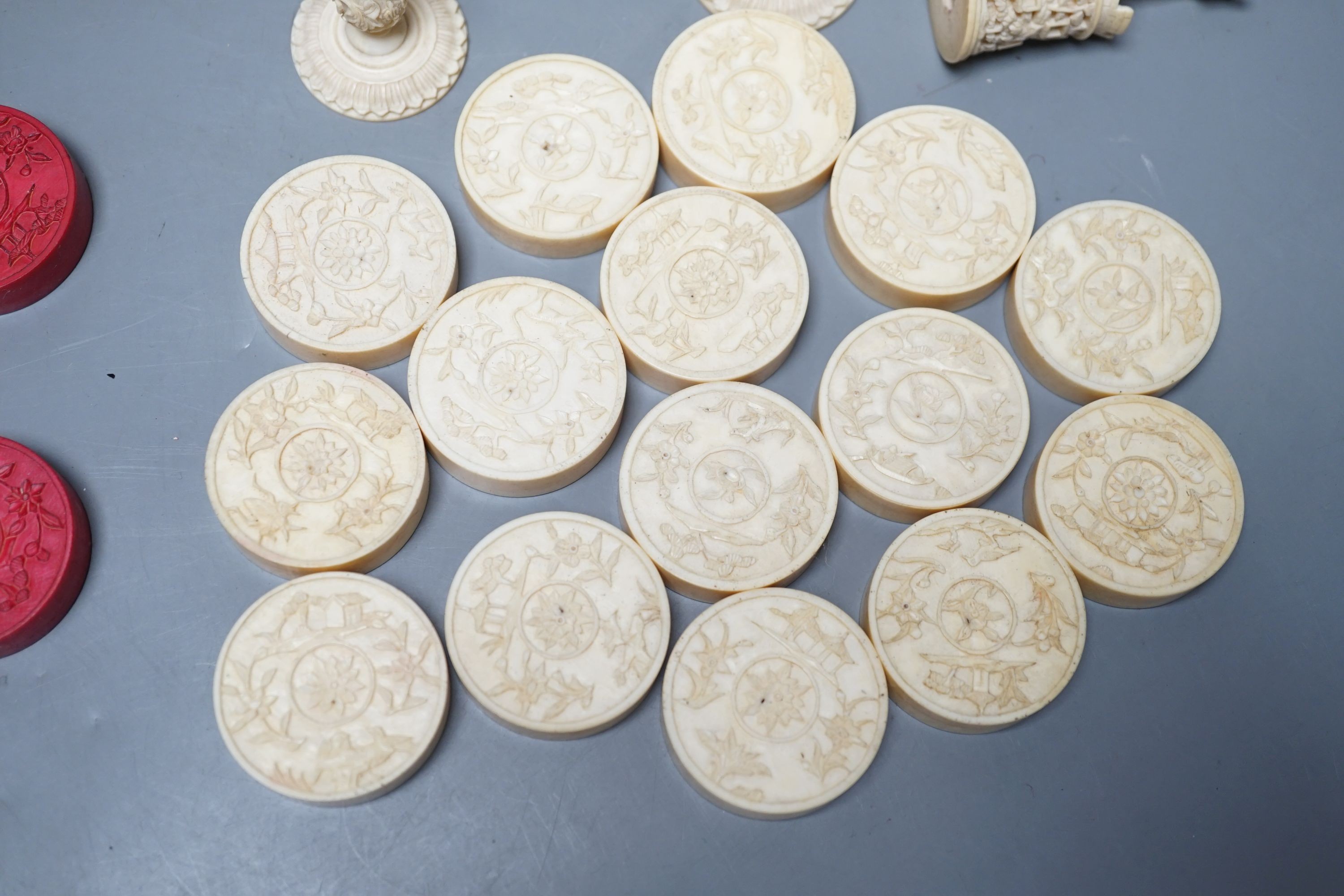 A 19th century Chinese export Burmese pattern carved and stained ivory chess set, one white pawn associated